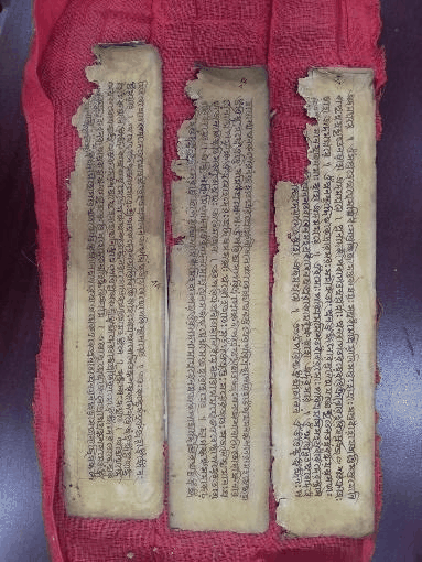 Handwritten Manuscripts on Red Cloth